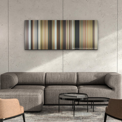 Ticket to Paradise color palette canvas on a concrete wall above a gray sectional sofa