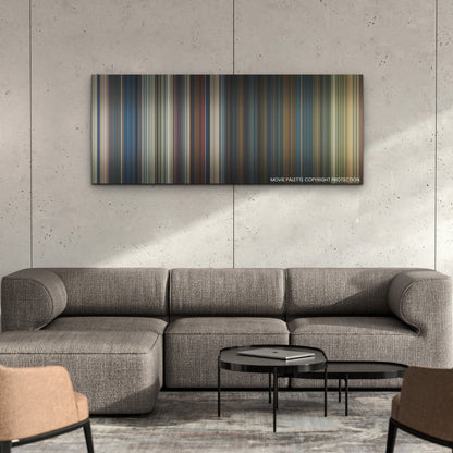 The Expendables 4 color palette canvas on a concrete wall above a gray sectional sofa