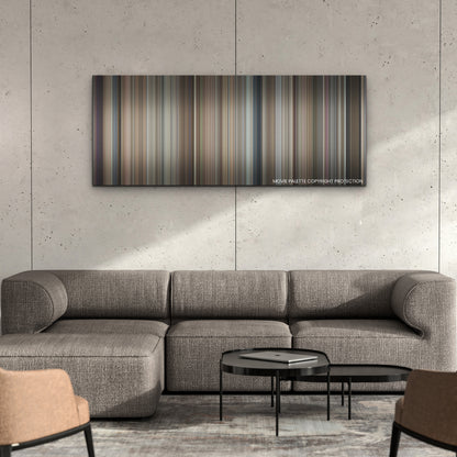 Pain Hustlers color palette canvas on a concrete wall above a gray sectional sofa
