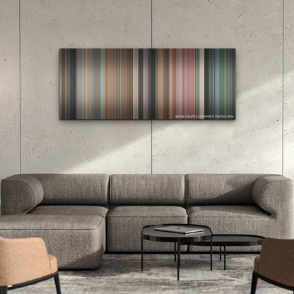 Bottoms color palette canvas on a concrete wall above a gray sectional sofa