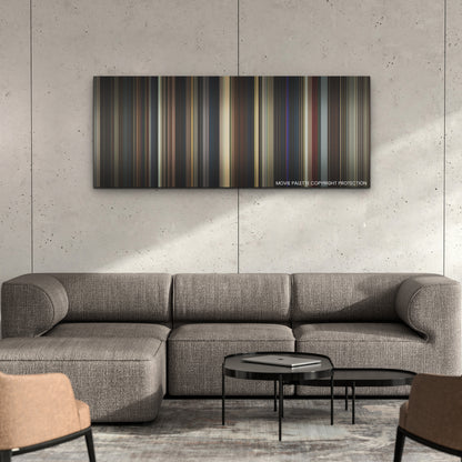 Saltburn color palette canvas on a concrete wall above a gray sectional sofa