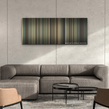 Reptile color palette canvas on a concrete wall above a gray sectional sofa