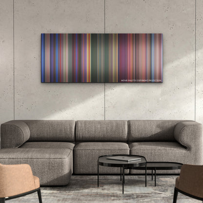 Transformers One color palette canvas on a concrete wall above a gray sectional sofa