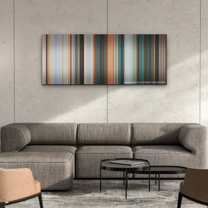 Wicked color palette canvas on a concrete wall above a gray sectional sofa