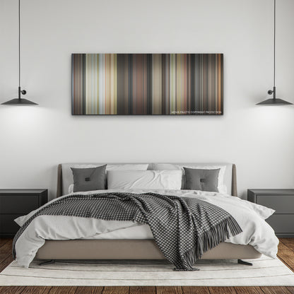 Glass Onion color palette canvas above a bed, between two black pendant lamps