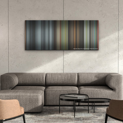 Maestro color palette canvas on a concrete wall above a gray sectional sofa