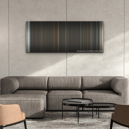 A Haunting in Venice color palette canvas on a concrete wall above a gray sectional sofa