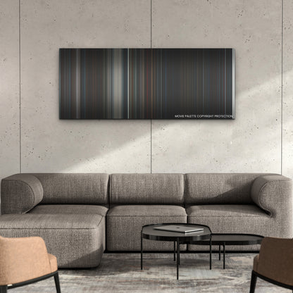 Hellraiser color palette canvas on a concrete wall above a gray sectional sofa