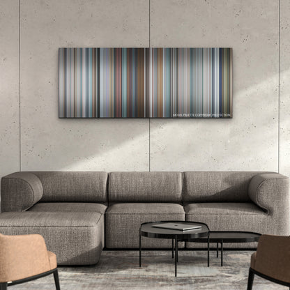 Free Guy color palette canvas on a concrete wall above a gray sectional sofa