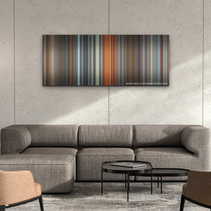 The Man from Toronto color palette canvas on a concrete wall above a gray sectional sofa