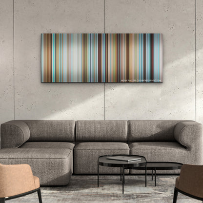 Nyad color palette canvas on a concrete wall above a gray sectional sofa