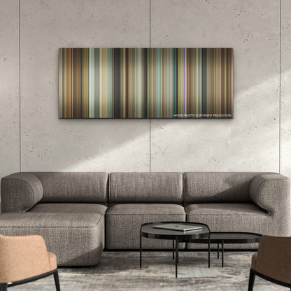 American Fiction color palette canvas on a concrete wall above a gray sectional sofa