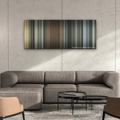 The King's Man color palette canvas on a concrete wall above a gray sectional sofa