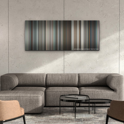 Emily the Criminal color palette canvas on a concrete wall above a gray sectional sofa