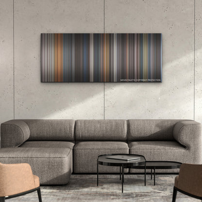 Boss Level color palette canvas on a concrete wall above a gray sectional sofa