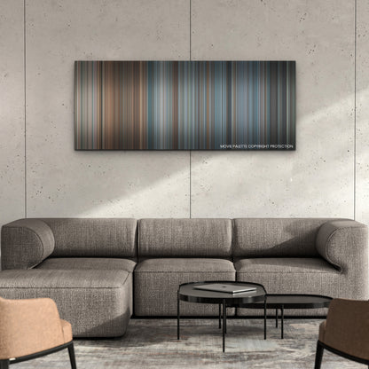 BlackBerry color palette canvas on a concrete wall above a gray sectional sofa