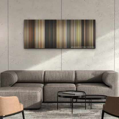 The Unbearable Weight of Massive Talent color palette canvas on a concrete wall above a gray sectional sofa