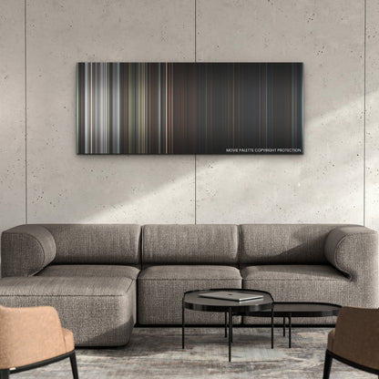 X color palette canvas on a concrete wall above a gray sectional sofa