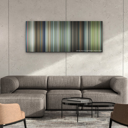 Leave the World Behind color palette canvas on a concrete wall above a gray sectional sofa