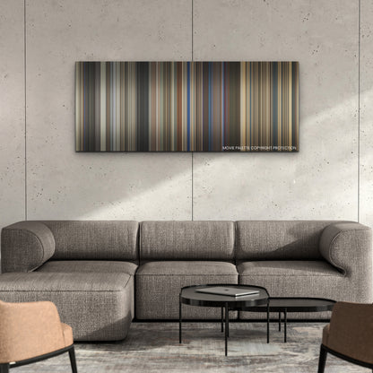The Family Plan color palette canvas on a concrete wall above a gray sectional sofa