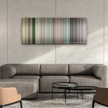Jackass Forever color palette canvas on a concrete wall above a gray sectional sofa
