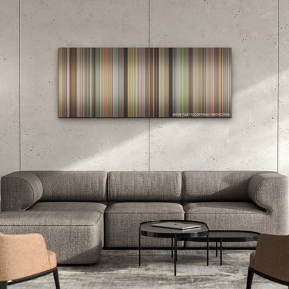 Unfrosted color palette canvas on a concrete wall above a gray sectional sofa