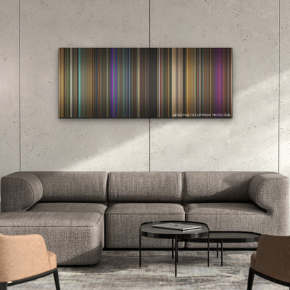 Monkey Man color palette canvas on a concrete wall above a gray sectional sofa