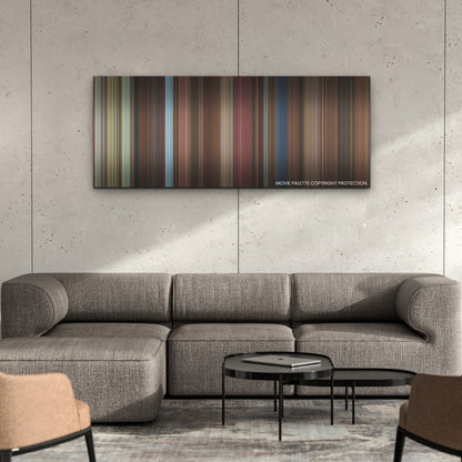 Love Hard color palette canvas on a concrete wall above a gray sectional sofa