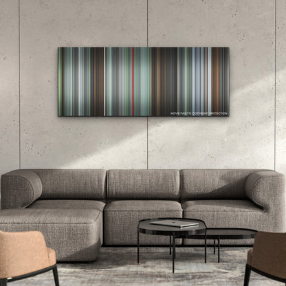 The Zone of Interest color palette canvas on a concrete wall above a gray sectional sofa