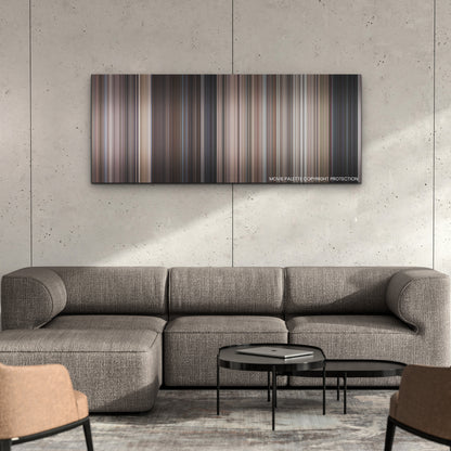 Operation Fortune: Ruse de Guerre color palette canvas on a concrete wall above a gray sectional sofa