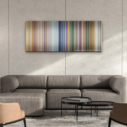 The Bad Guys color palette canvas on a concrete wall above a gray sectional sofa