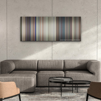 Ricky Stanicky color palette canvas on a concrete wall above a gray sectional sofa