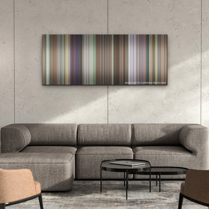 Joy Ride color palette canvas on a concrete wall above a gray sectional sofa