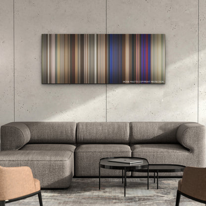 Old Dads color palette canvas on a concrete wall above a gray sectional sofa