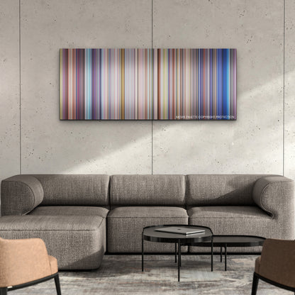 Sing 2 color palette canvas on a concrete wall above a gray sectional sofa