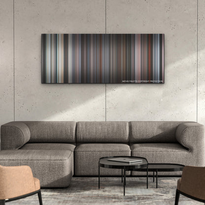 The Lost Daughter color palette canvas on a concrete wall above a gray sectional sofa