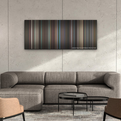 Creed III color palette canvas on a concrete wall above a gray sectional sofa