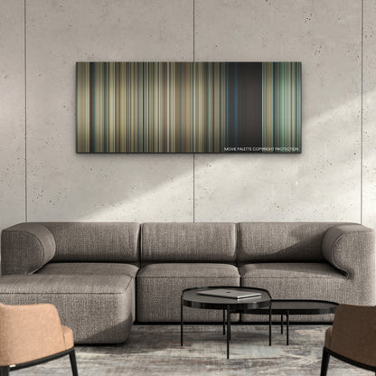 Old color palette canvas on a concrete wall above a gray sectional sofa