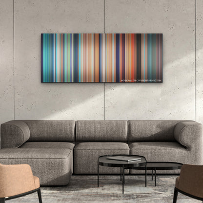Luca color palette canvas on a concrete wall above a gray sectional sofa