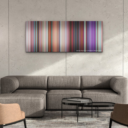 Turning Red color palette canvas on a concrete wall above a gray sectional sofa