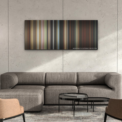 Beau Is Afraid color palette canvas on a concrete wall above a gray sectional sofa