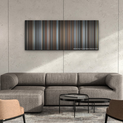 T√°r color palette canvas on a concrete wall above a gray sectional sofa