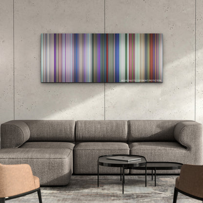 Spellbound color palette canvas on a concrete wall above a gray sectional sofa