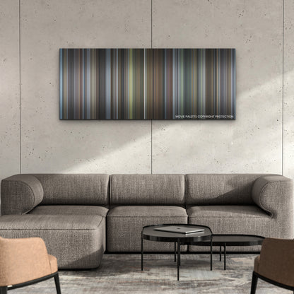 The Holdovers color palette canvas on a concrete wall above a gray sectional sofa