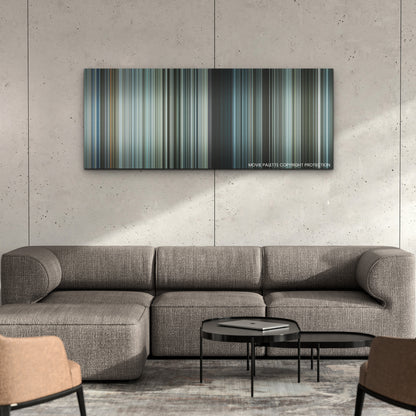 Sisu color palette canvas on a concrete wall above a gray sectional sofa