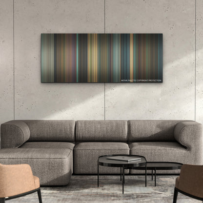 West Side Story color palette canvas on a concrete wall above a gray sectional sofa