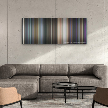 The Marvels color palette canvas on a concrete wall above a gray sectional sofa