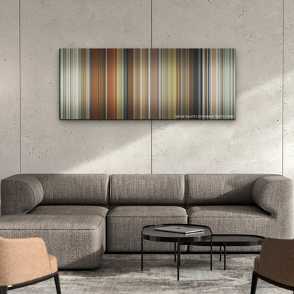 Spencer color palette canvas on a concrete wall above a gray sectional sofa