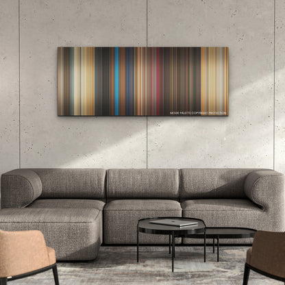 The Fall Guy color palette canvas on a concrete wall above a gray sectional sofa