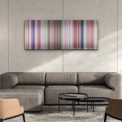 Barbie color palette canvas on a concrete wall above a gray sectional sofa